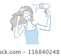A woman drying her hair with a dryer. 116840248