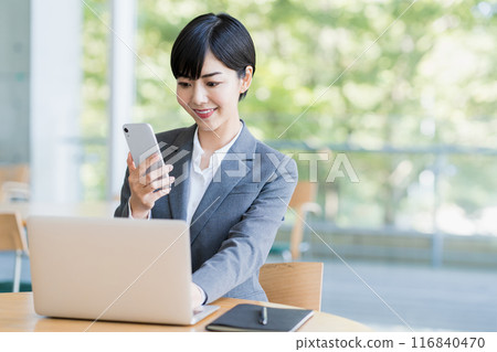 A young woman working in a cafe. 116840470
