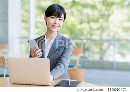 A young woman working in a cafe. A young woman working in a cafe. 116840471
