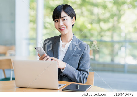 A young woman working in a cafe. 116840472