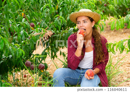 Young lady eating juicy peach 116840611