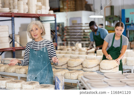 Portrait of senior woman potter in workshop 116841120