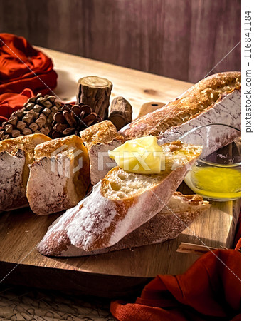 Freshly baked French bread and butter breakfast set: close-up shot of delicious bread and fresh butter on the table Freshly baked French bread and butter breakfast set: close-up shot of delicious bread and fresh butter on the table 116841184
