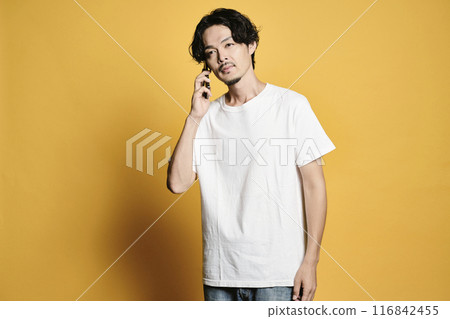 A man making a phone call on a color background 116842455
