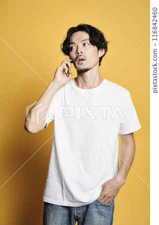 A man making a phone call on a color background 116842460