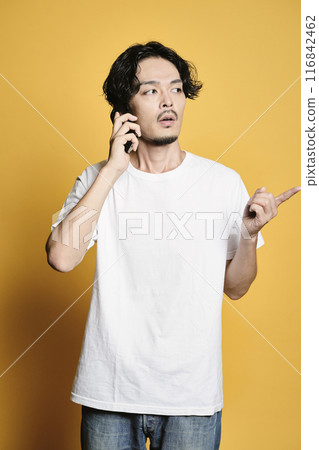 A man making a phone call on a color background 116842462