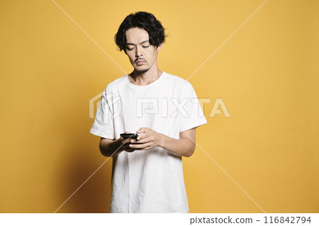 A man touching a smartphone with a colored background A man touching a smartphone with a colored background 116842794
