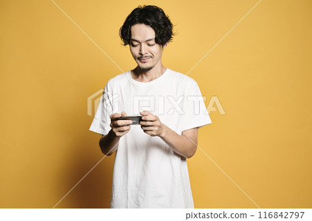 A man touching a smartphone with a colored background A man touching a smartphone with a colored background 116842797