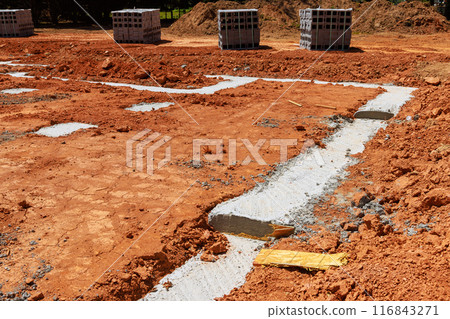 Delivery of concrete blocks to construction site with foundation for installation of cement block wall 116843271
