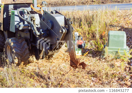 Trencher cable plow tractor is used to lay fiber optic cables 116843277