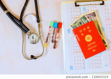 Medical care in Japan is expensive, with stethoscopes an electrocardiograms ECGs heart with Japanese passport, using Japanese yen Medical care in Japan is expensive, with stethoscopes an electrocardiograms ECGs heart with Japanese passport, using Japanese yen 116843324