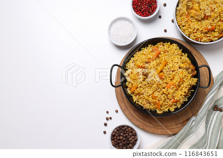 Pilaf and spices on white background, space for text 116843651