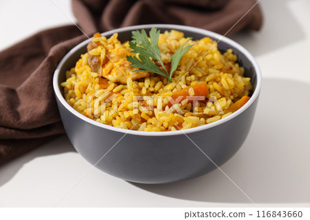 Pilaf in bowl and towel on white background, close up Pilaf in bowl and towel on white background, close up 116843660