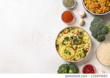Pilaf in bowls, rice, spice and vegetables on white background, space for text 116843683