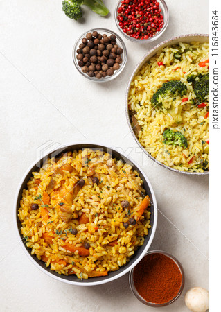 Pilaf in bowls and red pepper on white background, top view Pilaf in bowls and red pepper on white background, top view 116843684