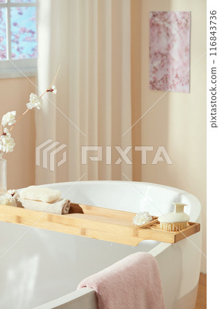 Bathroom concept photo for advertise product of cosmetic or beauty care, a blank label tube placed on the white table top, next to two bath sponges. Empty space for designing and advertising 116843736