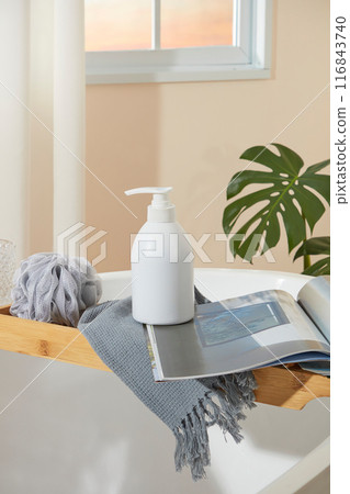 The cosmetic advertising template photo in green color tone bathroom, from front view. Above of white cabinet contains a sink with a green towel covered, a brush and tree pot, blank space in center 116843740