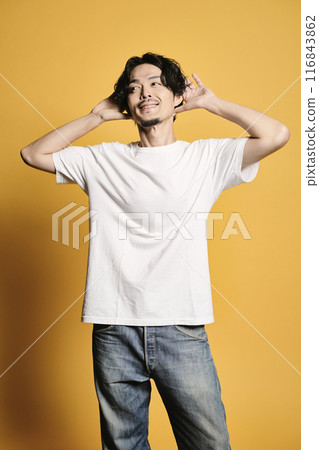 A man posing with a colored bag A man posing with a colored bag 116843862