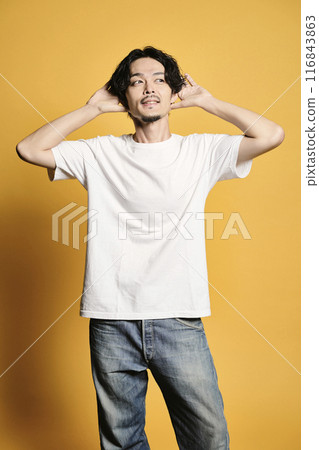 A man posing with a colored bag A man posing with a colored bag 116843863