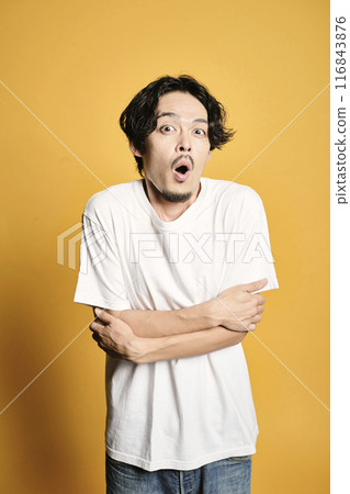 A man posing with a colored bag A man posing with a colored bag 116843876