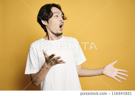 A man posing with a colored bag 116843881