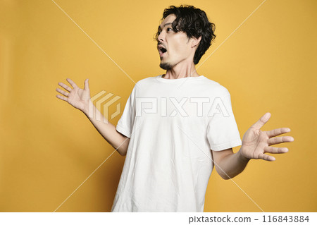 A man posing with a colored bag 116843884