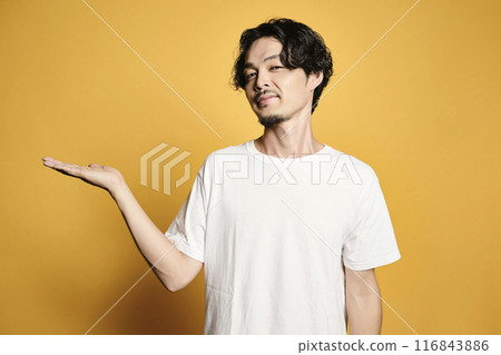 A man posing with a colored bag 116843886