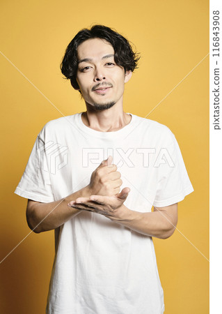 A man posing with a colored bag A man posing with a colored bag 116843908