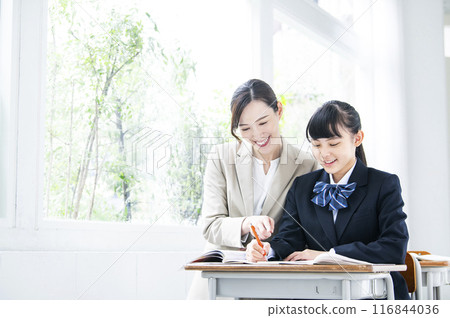 Junior high school girls studying with a female teacher Junior high school girls studying with a female teacher 116844036