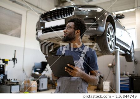 Auto mechanic checking car repair in service workshop Auto mechanic checking car repair in service workshop 116844749