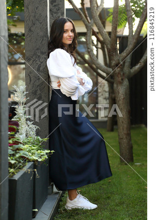 Teenage girl posing for a photographer. Young and beautiful teenage girl.  116845219