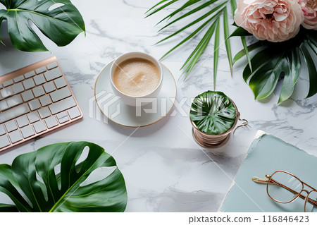 Flat lay white coffee cup of coffee on a white plate on a marble countertop, green plant. Concept of relaxation and tranquility 116846423
