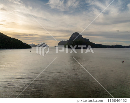 Island and boats under blue sky and clouds. El Nido, Palawan. Philippines. Island and boats under blue sky and clouds. El Nido, Palawan. Philippines. 116846462
