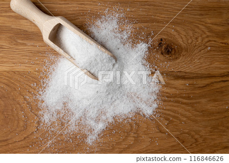 salt in wooden skoop isolated on wooden background salt in wooden skoop isolated on wooden background 116846626