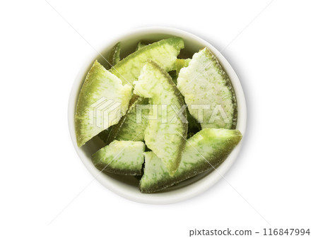 Bowl with dried green grapefruit slices isolated on white background. Bowl with dried green grapefruit slices isolated on white background. 116847994
