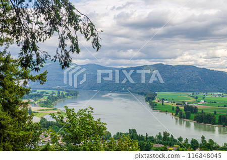 View of the Mission town with Fraser River, lush green valley and the mountains in the background - Fraser Valley, BC, Canada 116848045