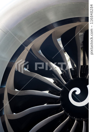 Turbine blades of an aircraft jet engine. Close up Turbines Engine. Aviation Technologies. Aircraft jet black detail during maintenance. Background. Turbine blades of an aircraft jet engine. Close up Turbines Engine. Aviation Technologies. Aircraft jet black detail during maintenance. Background. 116848284