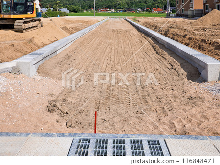 Housing development and road under construction 116848471