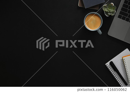 Top view laptop, cup of coffee and notebook on black background with copy space 116850062