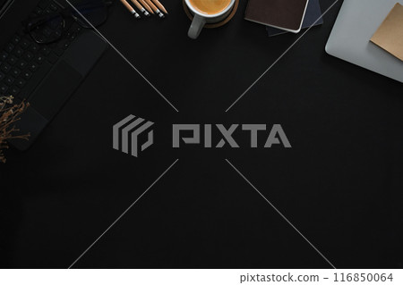Stylish workspace laptop, cup of coffee and notebook on black background. Top view with copy space 116850064