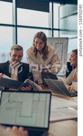 Coworkers discussing biz related problem in the office and using laptop. Conception of business team Coworkers discussing biz related problem in the office and using laptop. Conception of business team 116850240