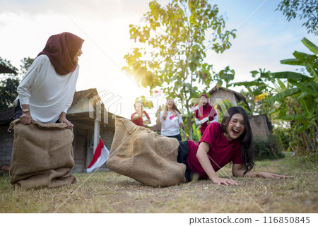 A group of women are playing a game with bags on the ground 116850845