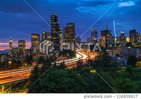 Seattle downtown skyline, with traffic on the I-5 freeway, viewed at dusk Seattle downtown skyline, with traffic on the I-5 freeway, viewed at dusk 116850917