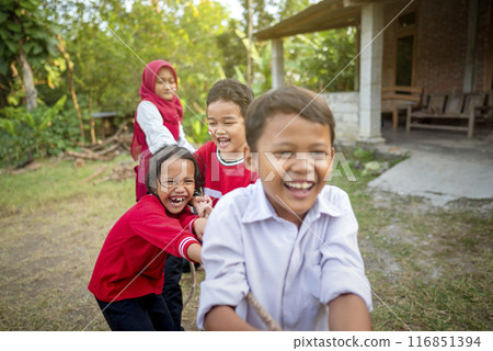 Portrait of Indonesian kids celebrate Indonesia Independence Day with traditional events like a tug of war contest 116851394