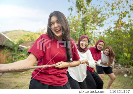 Portrait of Indonesian woman celebrate Indonesia Independence Day with traditional events like a tug of war contest 116851397