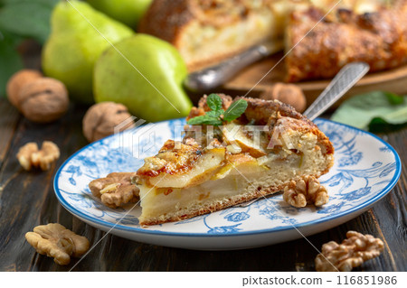 Piece of open pie (biscuits) with pears, blue cheese and walnuts. Piece of open pie (biscuits) with pears, blue cheese and walnuts. 116851986