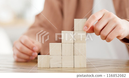 A man stacking building blocks A man stacking building blocks 116852082