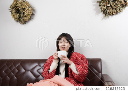 Winter woman relaxing in a room Winter woman relaxing in a room 116852623
