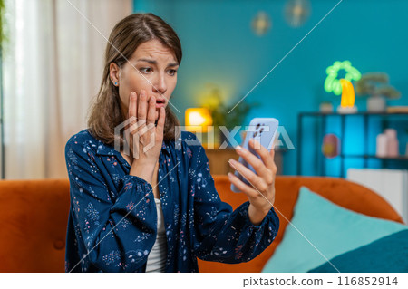 Sad displeased Caucasian woman using smartphone receive bad news, fortune loss fail, deadline, virus Sad displeased Caucasian woman using smartphone receive bad news, fortune loss fail, deadline, virus 116852914
