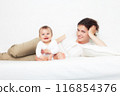 Mother playing with baby on white 116854376